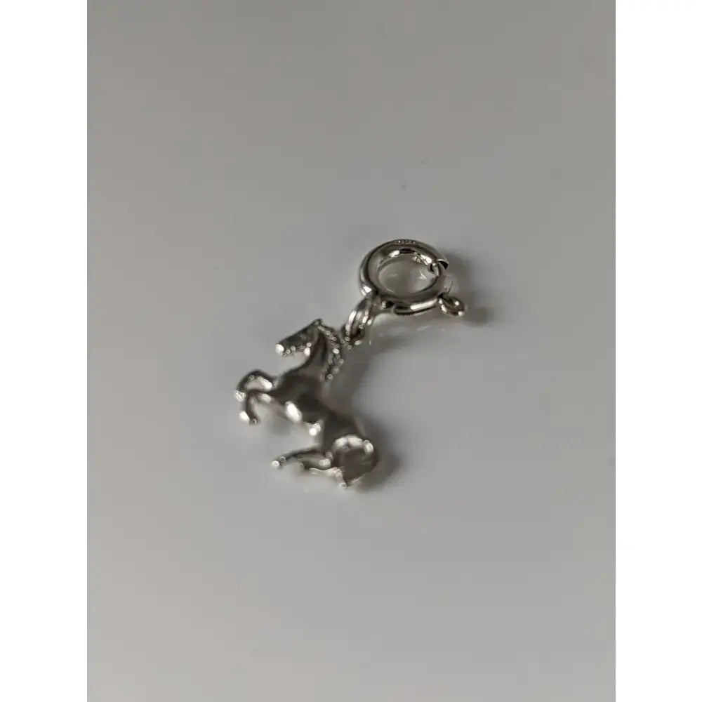 Silver steed galloping horse silver charm with polished metallic finish and attached clasp for easy wear