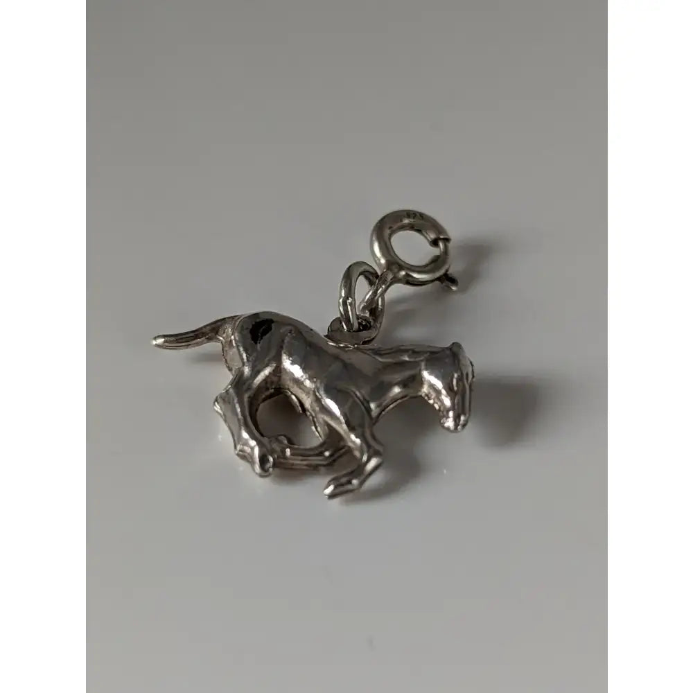 Silver steed galloping horse silver charm with polished metallic finish and detailed sculpted features