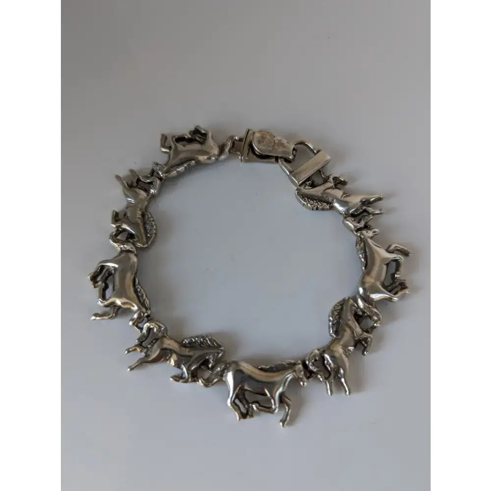 Silver steed silver galloping horses bracelet featuring a silver horses bracelet with detailed sculpted figures linked together