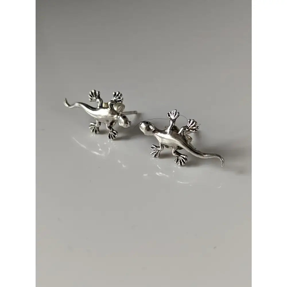Silver steed gecko stud earrings with detailed articulated limbs and tails in shiny silver metal