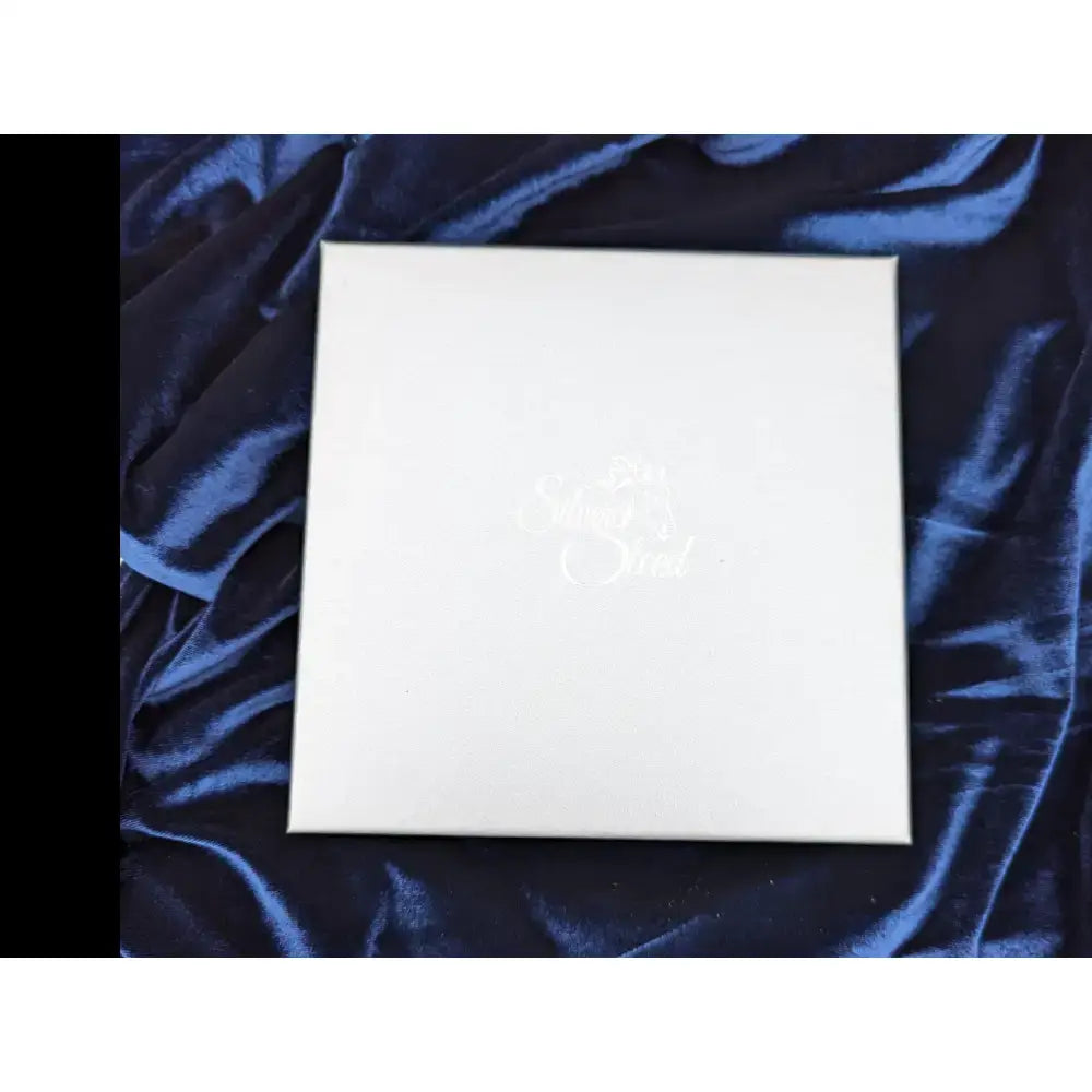 White square silver steed gift box with subtle silver cursive lettering on the lid perfect for stylish gift boxes