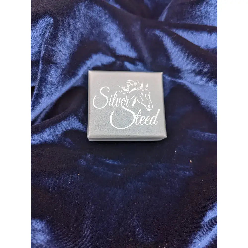 Silver steed gift box with white horse silhouette and cursive lettering on dark blue velvet for steed gift boxes