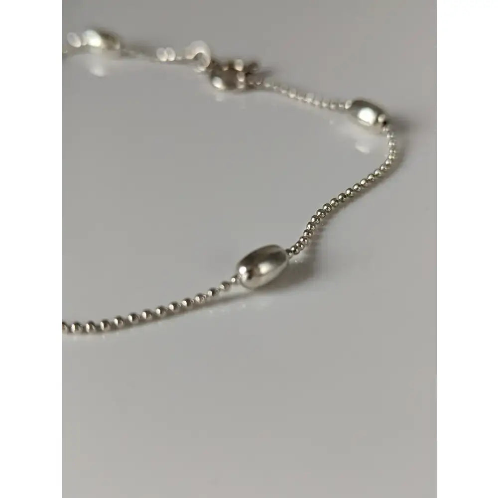 Silver steed grain chain silver bracelet with silver beads and smooth oval metallic charms handmade silver bracelet