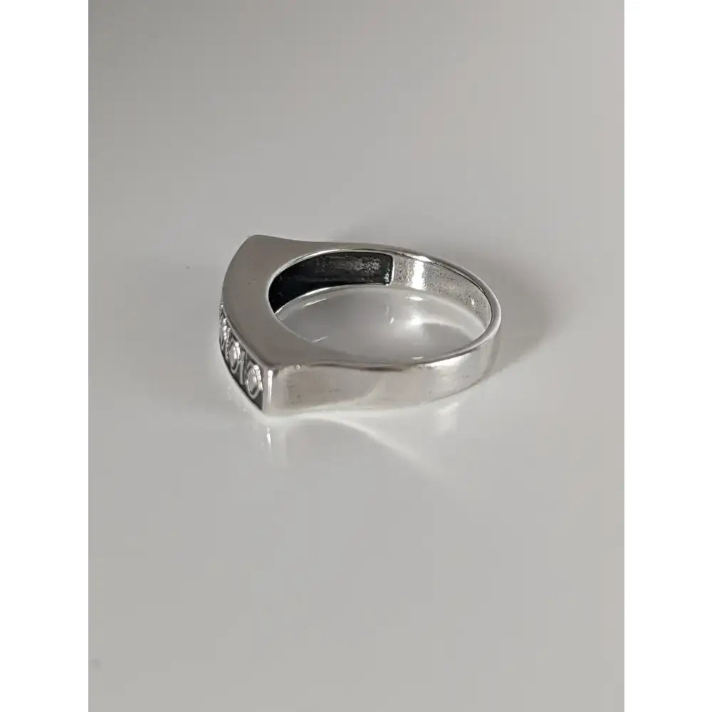 Silver steed greek theme ring with sleek silver band and three round-cut diamonds showing a radiant sheen