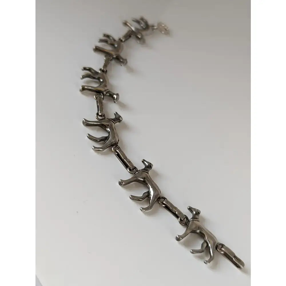 Silver steed greyhound silver bracelet crafted with articulated silver-toned dog figures linked in a continuous chain