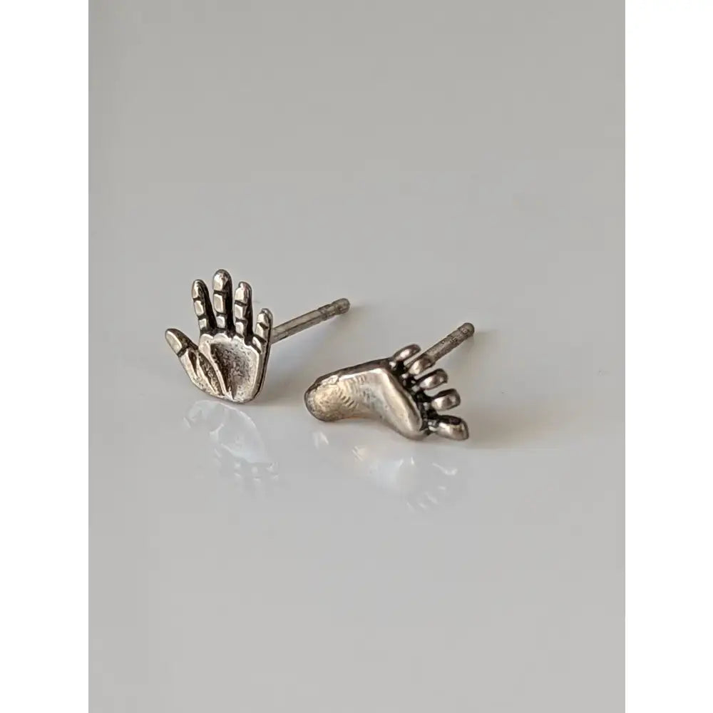 Silver steed hand and foot stud earrings featuring detailed textured designs in sterling silver for stylish wear