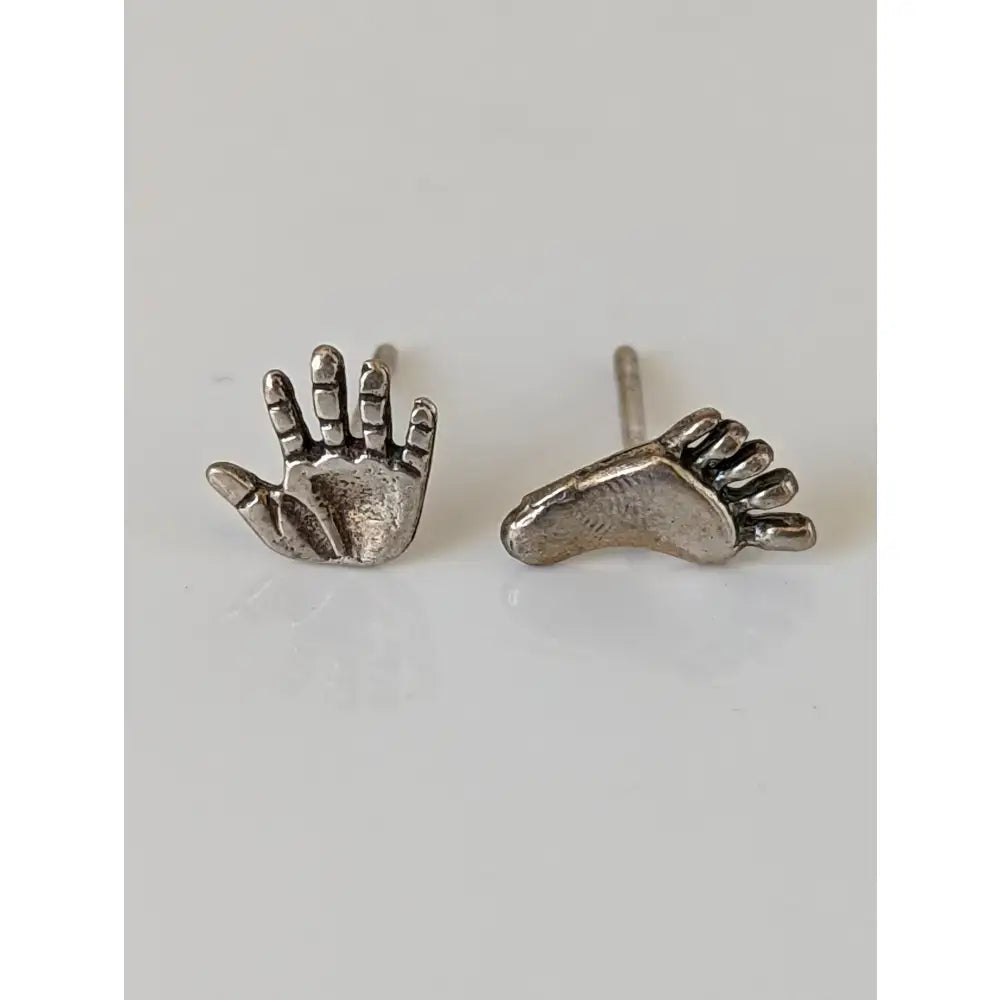 Silver steed hand and foot stud earrings with detailed textured impressions in sterling silver for stylish wear