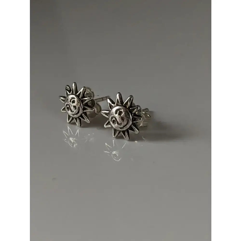 Silver steed happy sun stud earrings with smiling sun-shaped silver studs and radiating rays