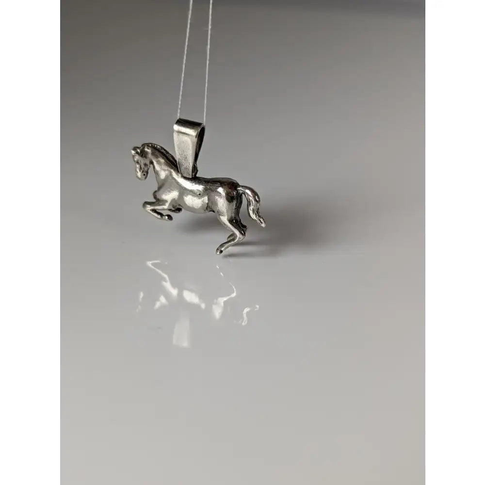 Silver steed haute ecole pendant featuring a polished silver equestrian pendant with detailed sculpted horse features