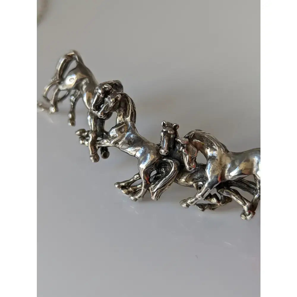 Silver metallic horse figurine set with intricate details and polished finish from silver steed herd necklace collection