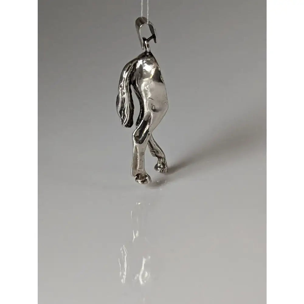 Silver steed hindquarters sterling silver pendant with polished reflective surface and detailed horse sculpted features