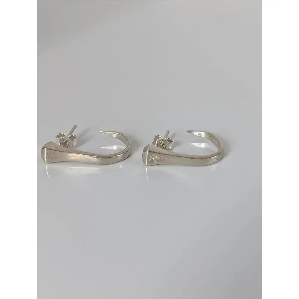 Silver steed hoofnail stud earrings with polished silver nail-shaped hoops and subtle engraved details