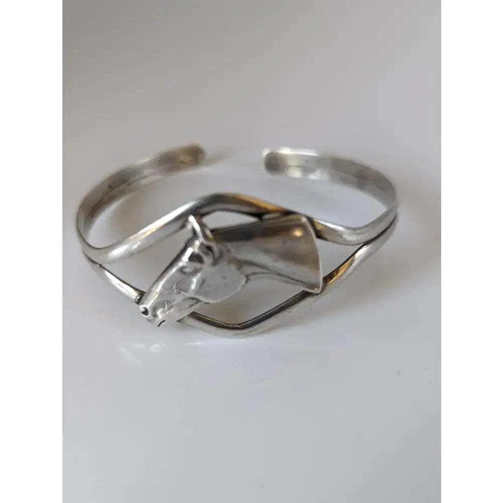 Silver steed horse head bangle with sleek open design and polished silver finish in a horse head bangle style