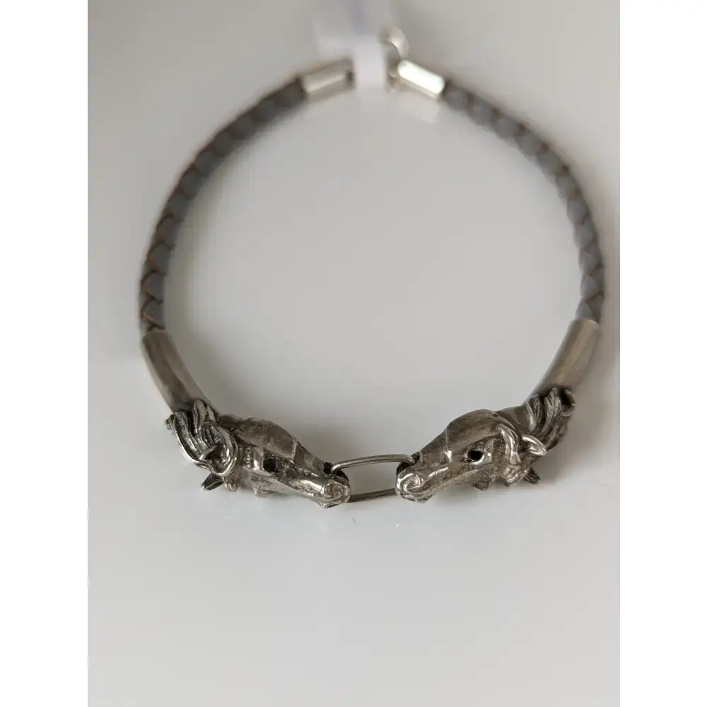 Silver steed horse head link bracelet with silver horse head charm, braided gray leather cord, and metallic clasp