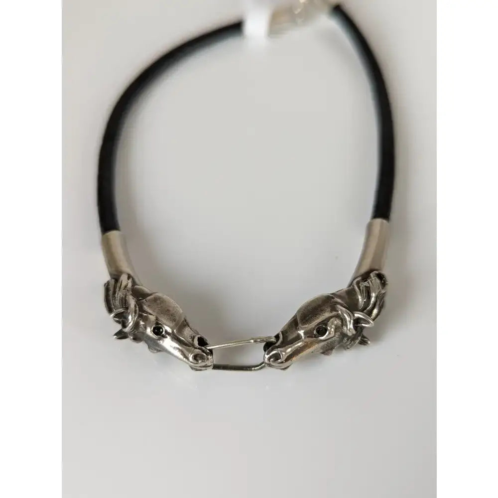 Silver steed horse head link bracelet with silver toggle, black leather cord, and metallic accents for everyday wear