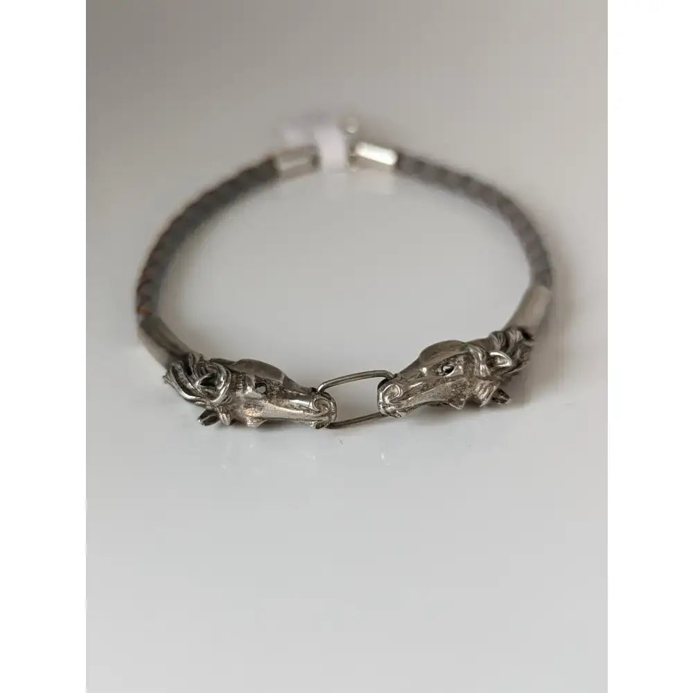 Silver steed silver-toned horse head link bracelet with textured metallic links and leather cord accents
