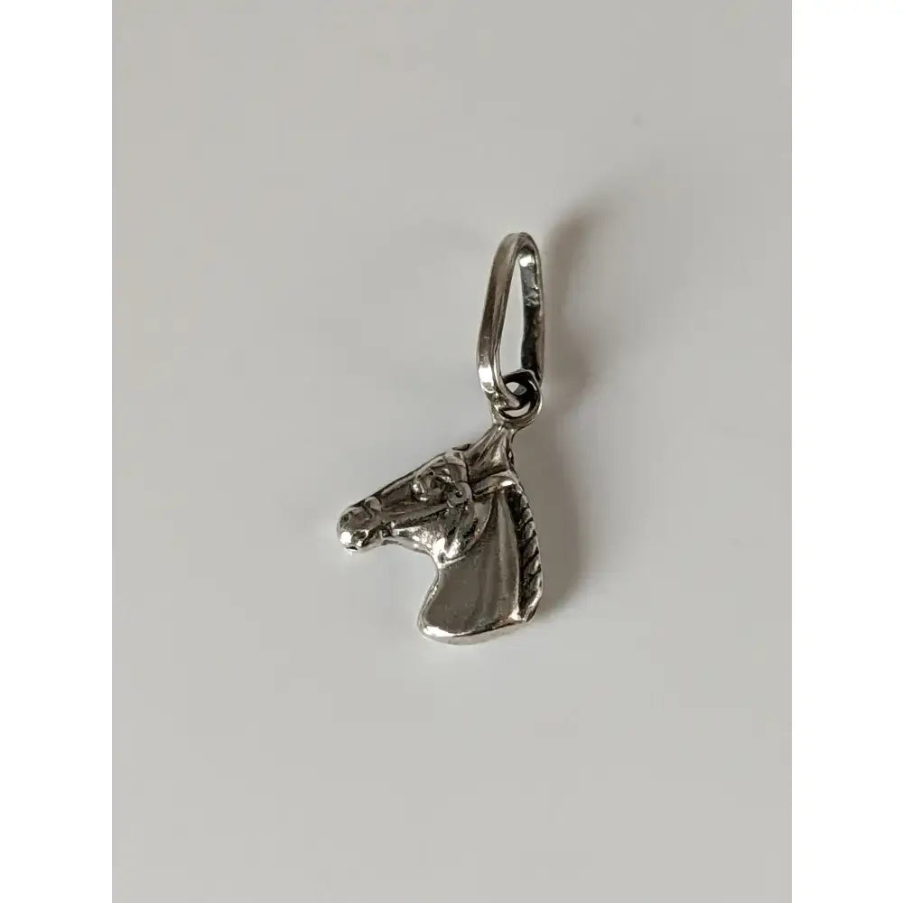 Silver pendant featuring a detailed silver steed horse head charm with a polished metallic finish