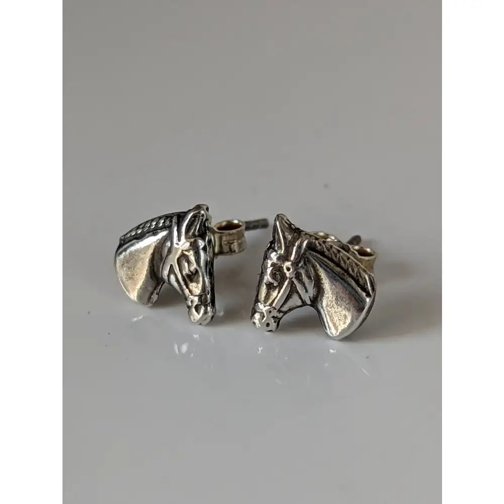 Silver steed horse head earrings with braided mane and textured silver metal finish perfect as head stud earrings