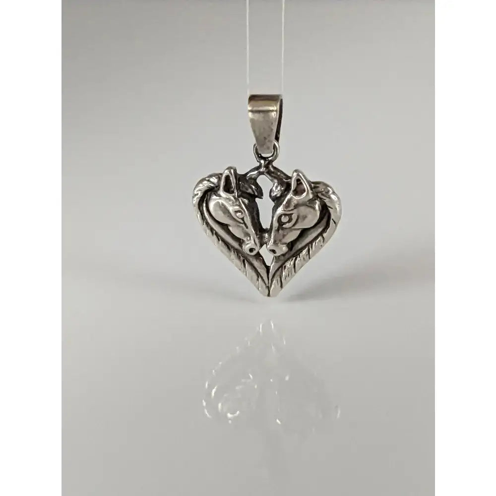 Silver steed horse heart pendant with two detailed silver horse heads facing each other in a shiny metal finish