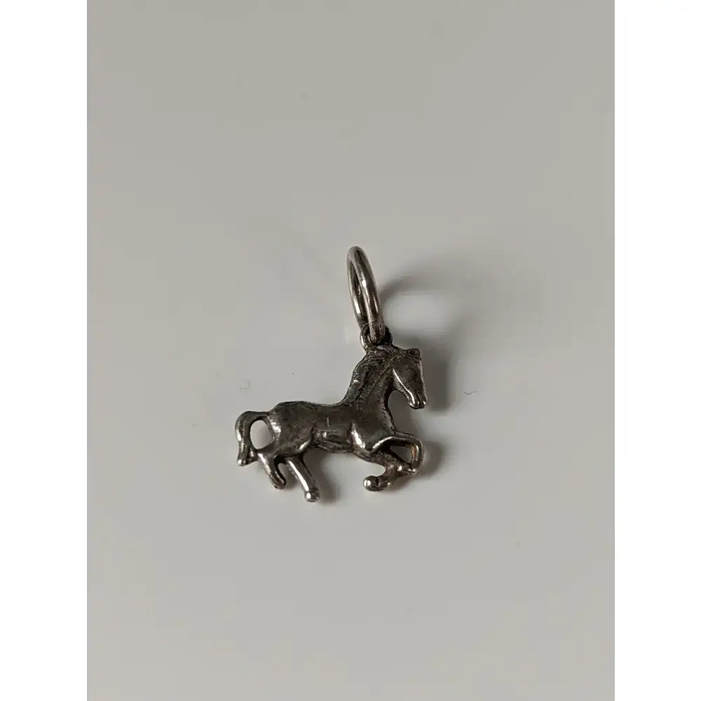 Silver steed horse silver pendant featuring a detailed sculpted silver horse charm with a loop for equestrian jewelry use