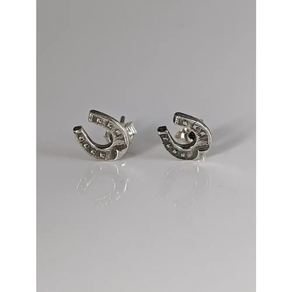 Silver steed horseshoe silver stud earrings with textured antiqued finish and engraved edge details