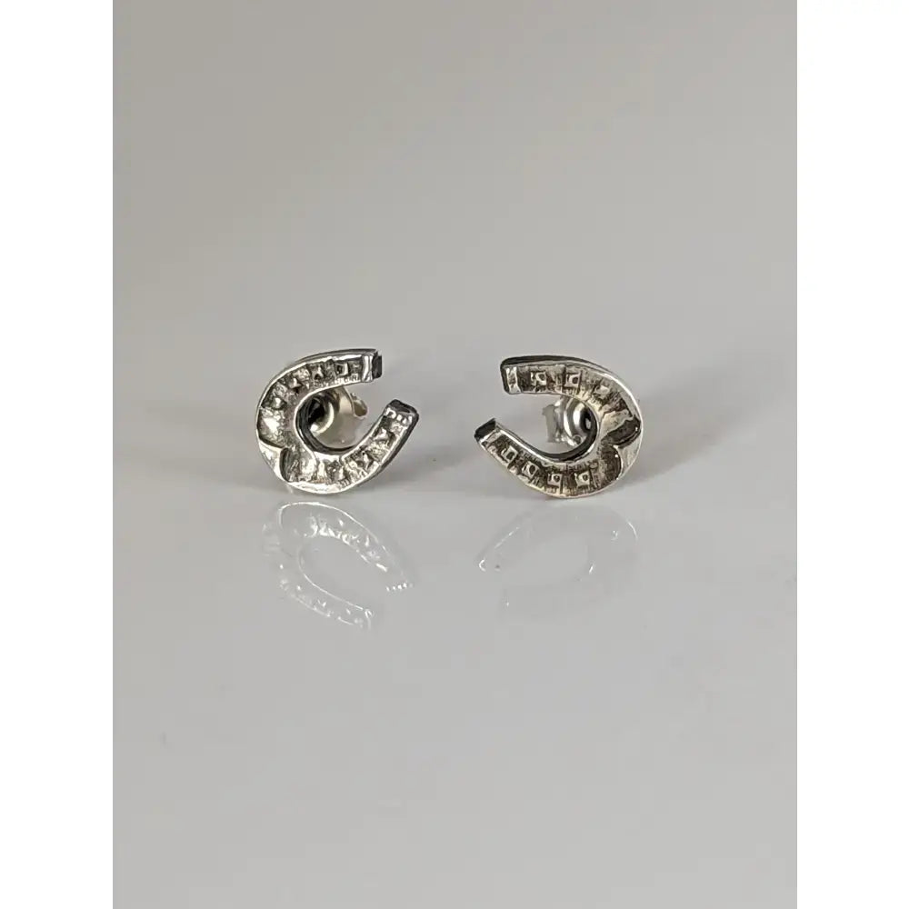 Silver steed horseshoe silver stud earrings with textured antiqued finish and subtle engraved edge detailing