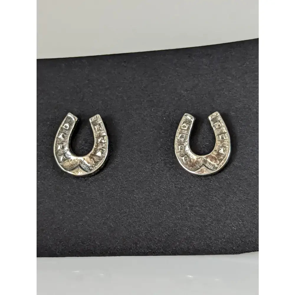 Silver steed horseshoe silver stud earrings with engraved lettering along curved edges in horseshoe shape