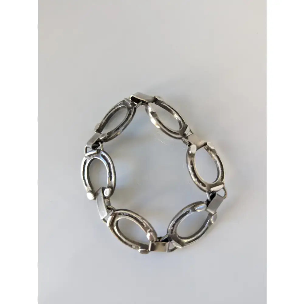 Silver steed horseshoe bracelet with polished silver horse hoof link and interlocking oval charms for equestrian jewelry