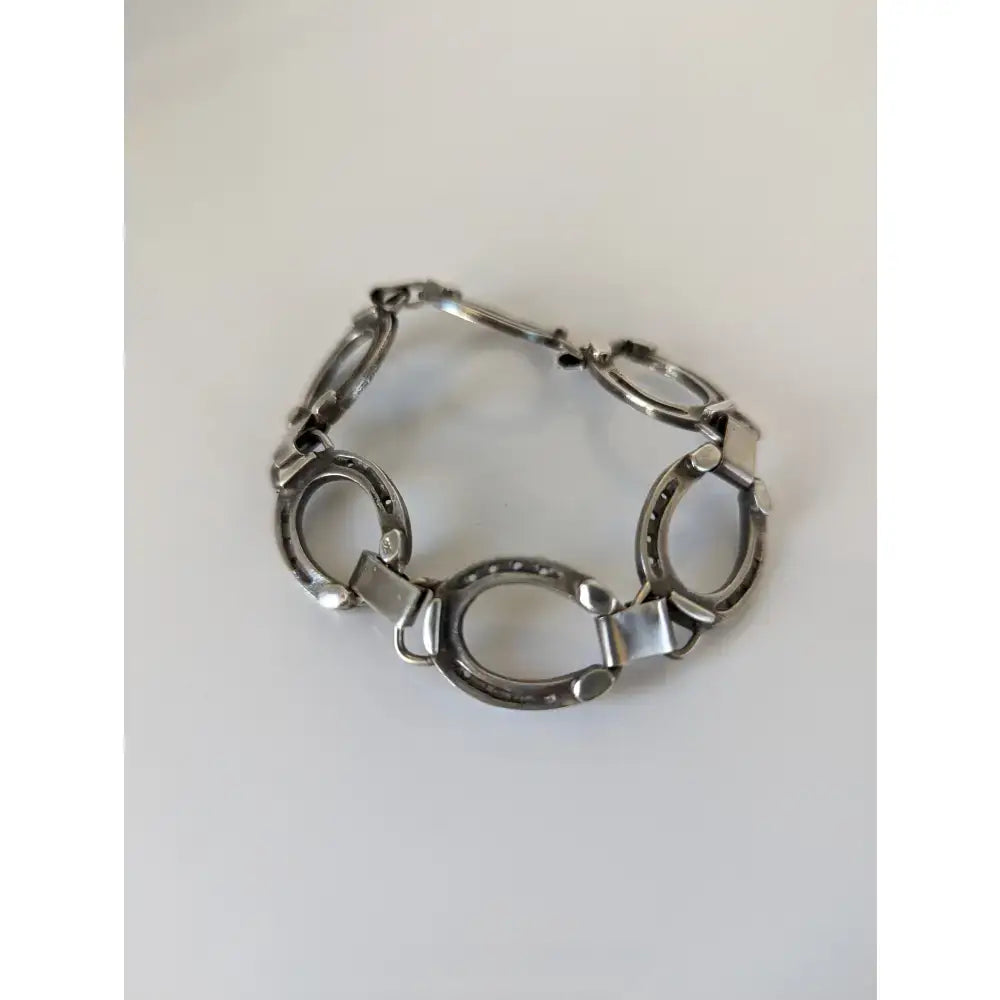 Silver steed horseshoe bracelet with silver-toned horseshoe links and polished metal connectors perfect equestrian jewelry