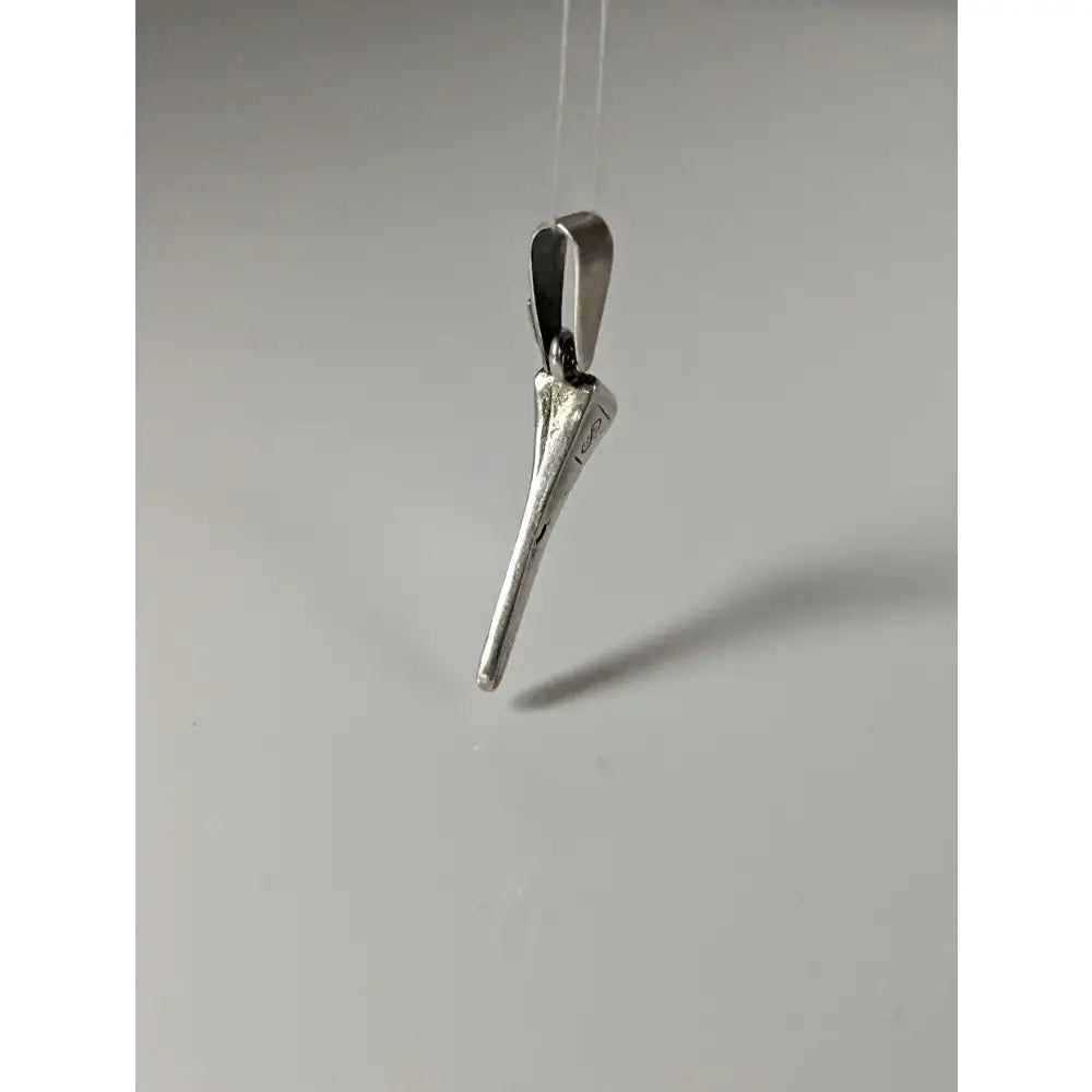 Silver pendant shaped like a stylized horseshoe nail with polished silver steed finish and engraved detail near top