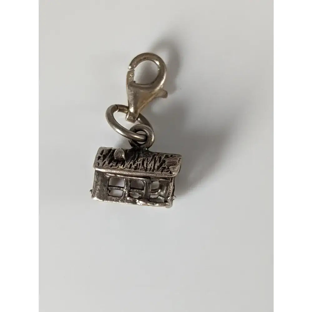 Silver steed house silver charm is a silver charm shaped like a miniature house with textured roof and lobster clasp for equestrian jewelry