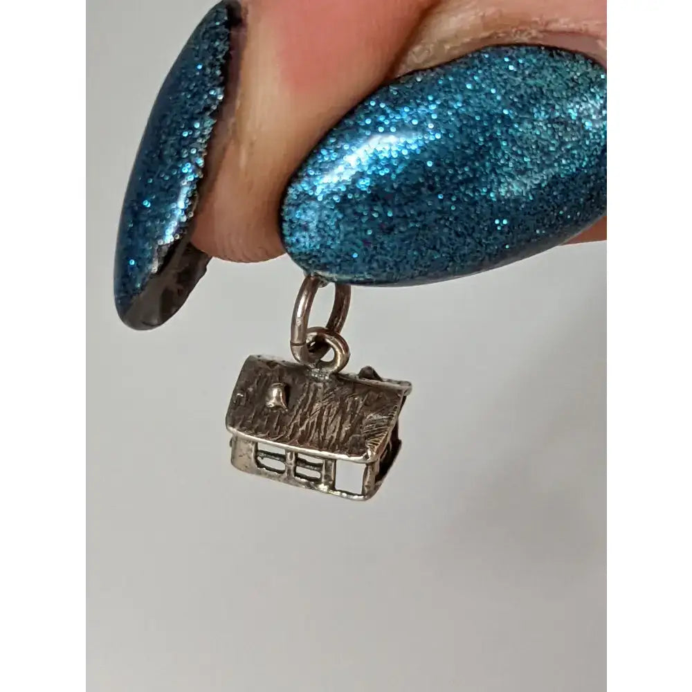 Silver steed house silver charm with textured roof and detailed windows perfect for equestrian jewelry fans
