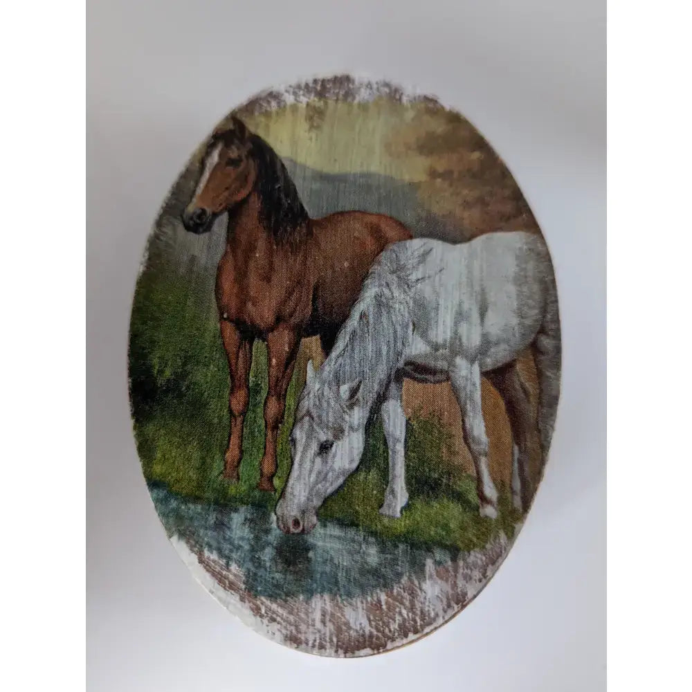 Oval-shaped silver steed jewellery box with painted brown and white horses scene in a pastoral setting