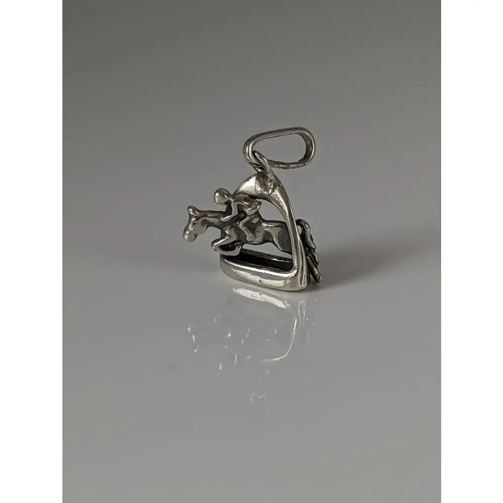 Silver steed jump silver jockey pendant with polished metallic finish and detailed equestrian figure mid-jump over stirrup