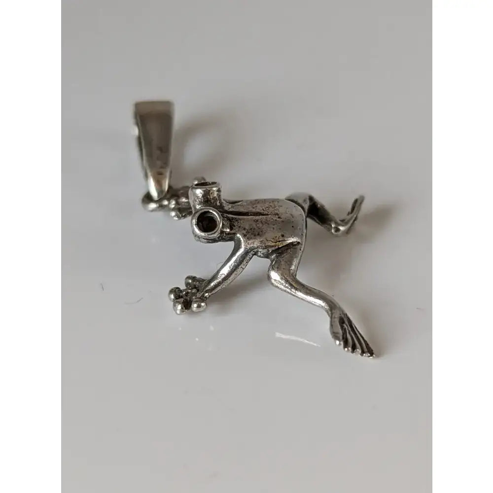Silver steed jumping frog pendant in sterling silver with detailed limbs and textured surface for unique style