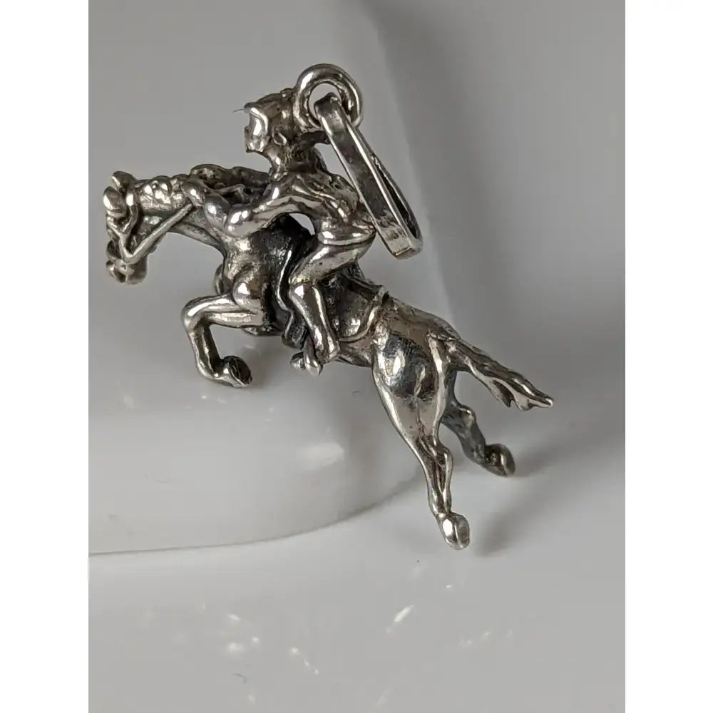Silver steed jumping jockey silver pendant featuring a detailed rider on horseback in polished silver metalwork