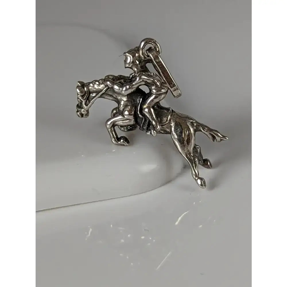 Silver steed jumping jockey silver pendant with detailed rider on horseback in metallic silver equestrian charm design