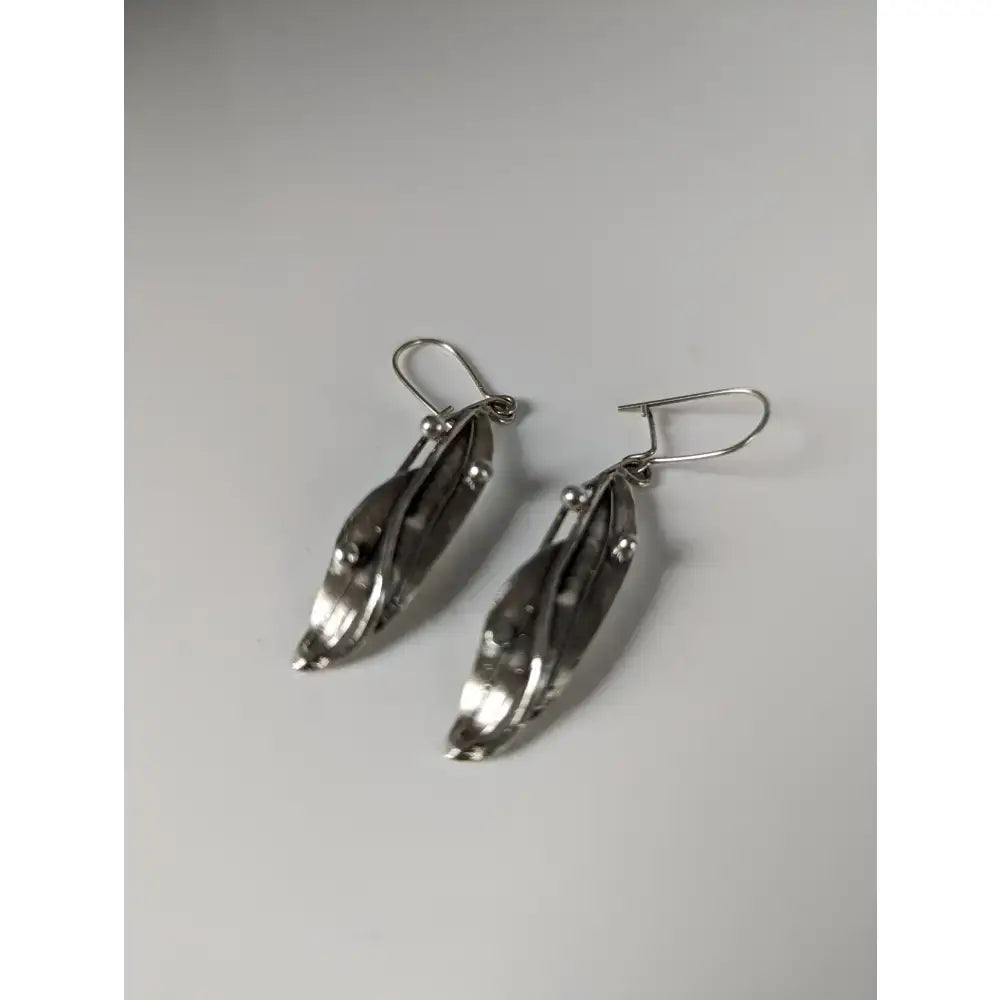 Silver steed kelp dropped earrings with sleek silver leaf shape and polished modern metallic finish