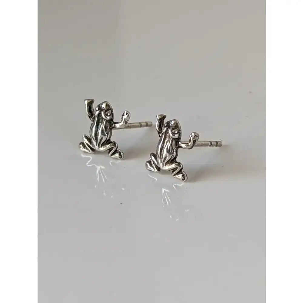 Silver steed leap frog stud earrings with detailed sculpted features and polished silver finish for everyday wear