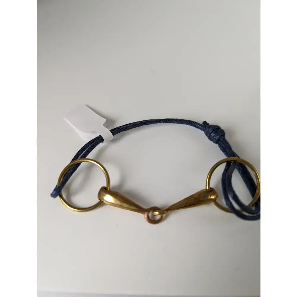Navy blue snaffle cord bracelet by silver steed leather with a central brass snaffle leather horsebit design and rings