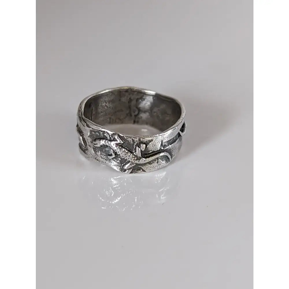 Silver steed lizard band is a silver steed lizard ring with a textured handcrafted design and embossed dragon motif