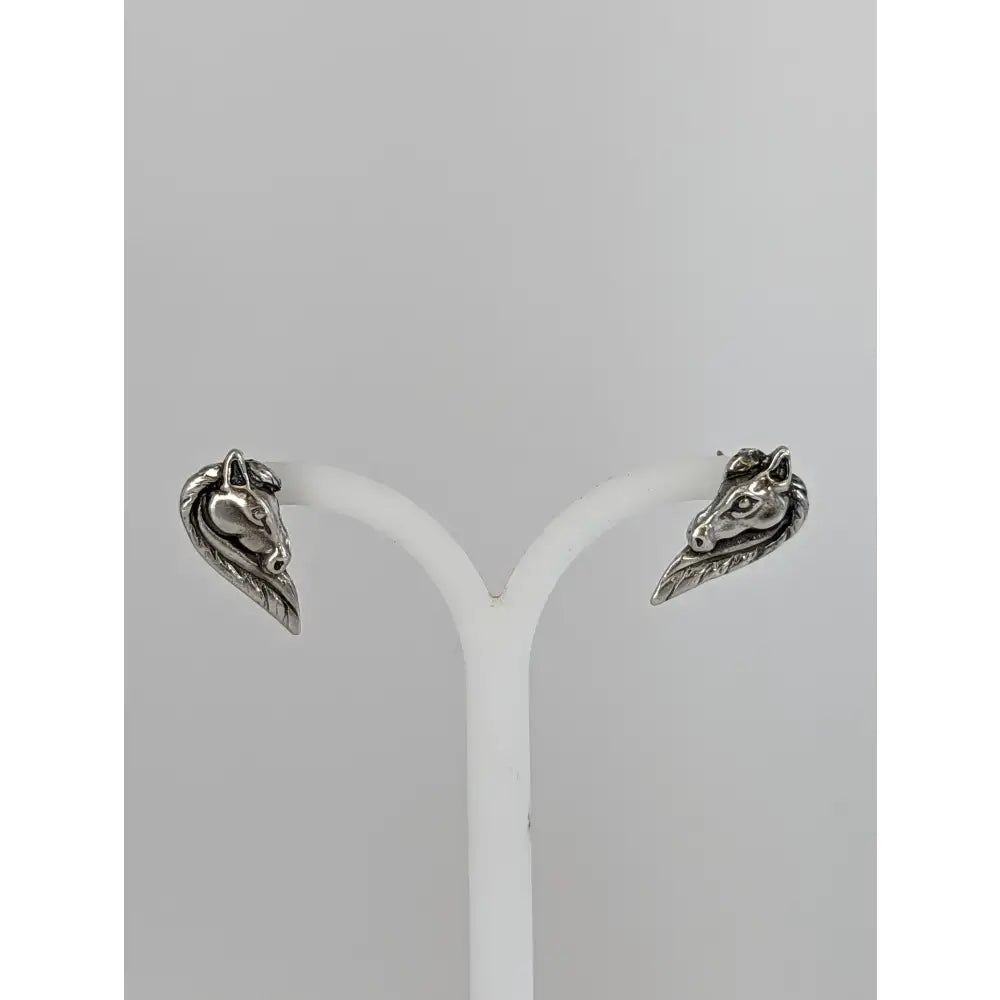 Silver steed horse head studs in silver with detailed facial features and flowing maned horse head design