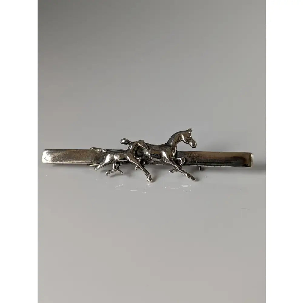 Silver stock tie pin featuring a detailed sculpted silver steed mare in mid-gallop as a foal brooch accessory