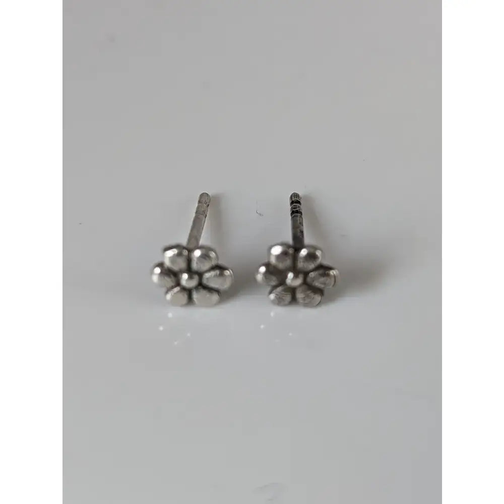 Silver steed margaret flower stud earrings with silver-toned five-petal flower design and textured finish