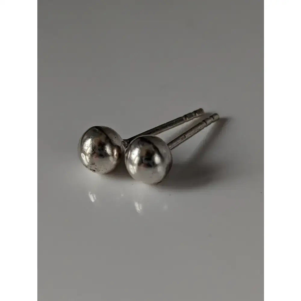 Silver steed medium ball stud earrings featuring minimalist silver polished spherical heads with slender posts