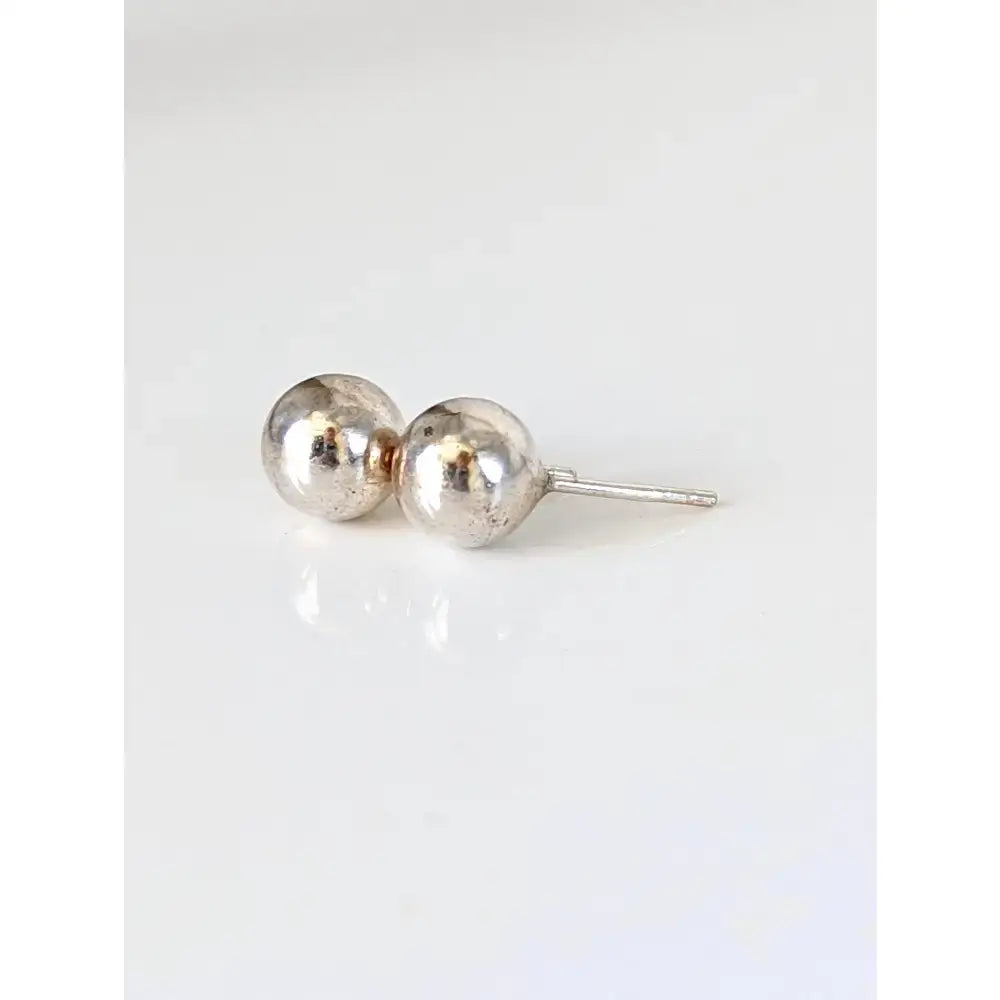 Silver steed medium balls stud earrings with two polished silver beads connected by a thin post