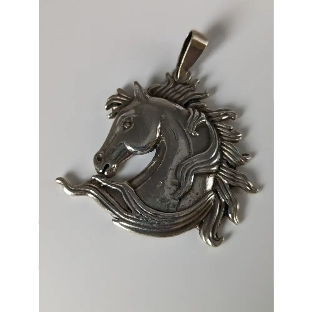 Silver steed mustang horse head silver pendant with detailed mane and flowing design in polished silver