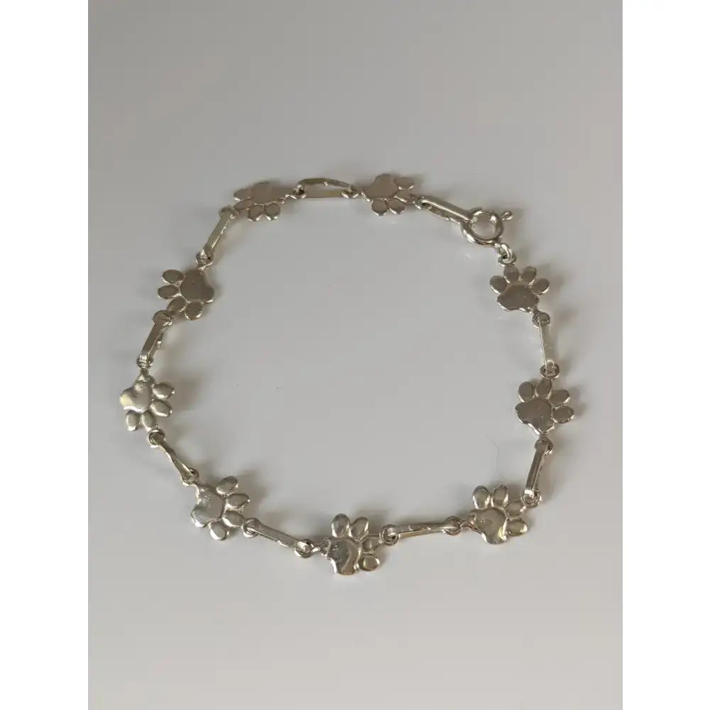 Silver steed paw print silver bracelet featuring a sterling silver delicate chain and paw print charm design
