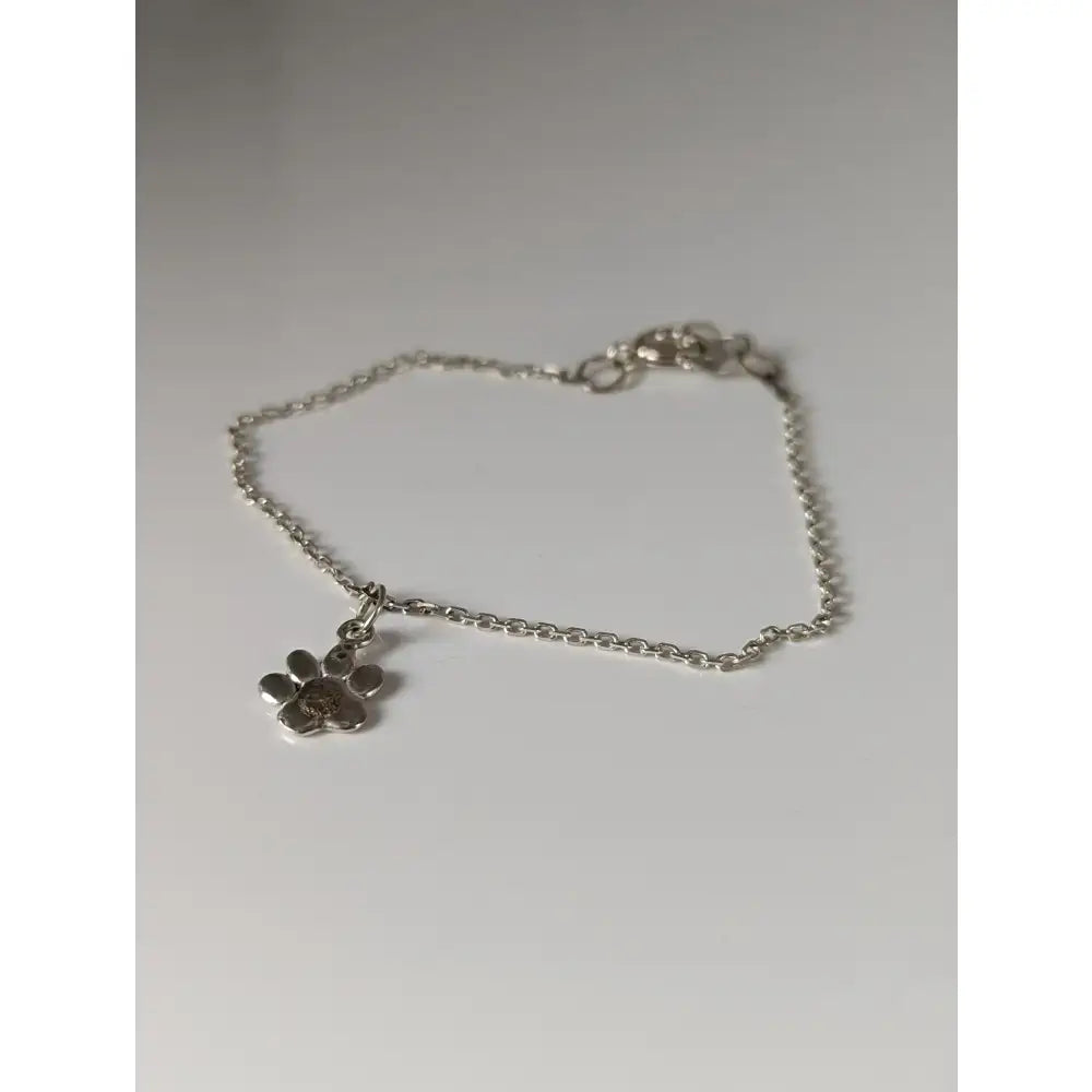 Silver steed paw print charm silver bracelet with sterling silver charm and delicate chain clasp in silver color