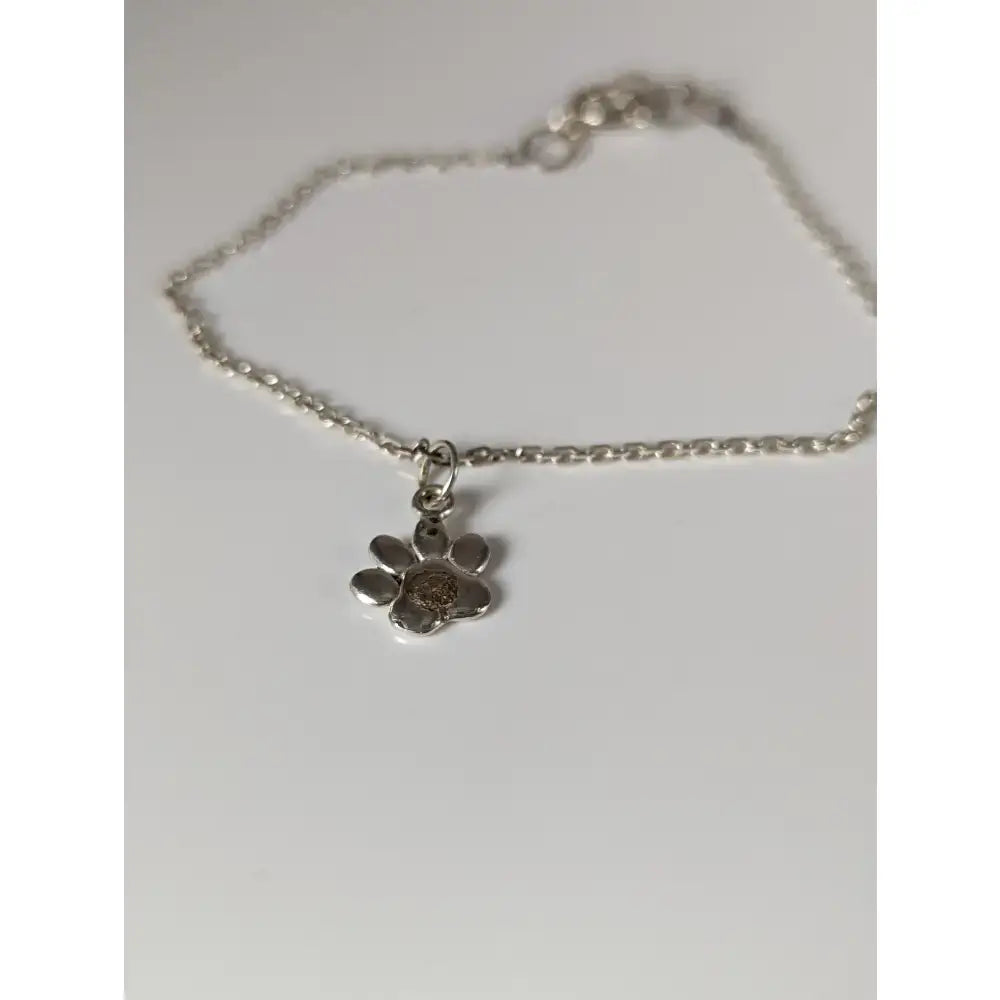 Silver steed paw print charm silver bracelet with a delicate sterling silver charm and polished pendant on a thin chain